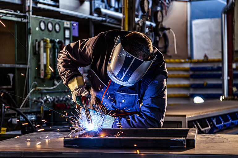 Industrial worker welding at the factory