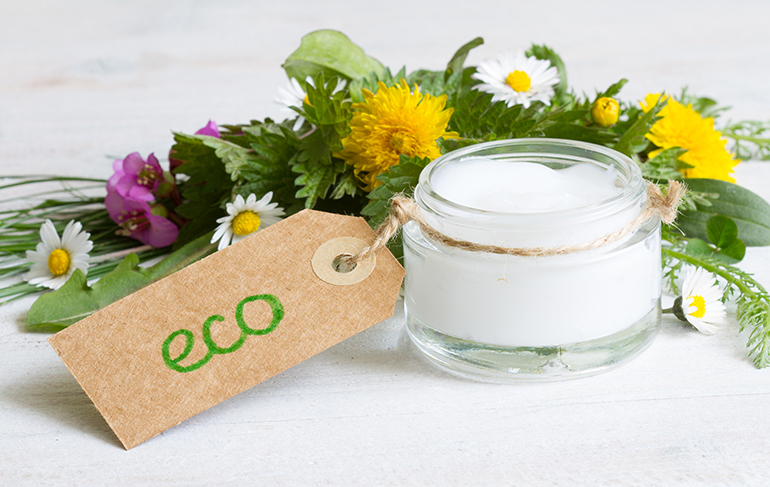 Natural cosmetics for skin care cream  eco label with herbs and flowers closeup