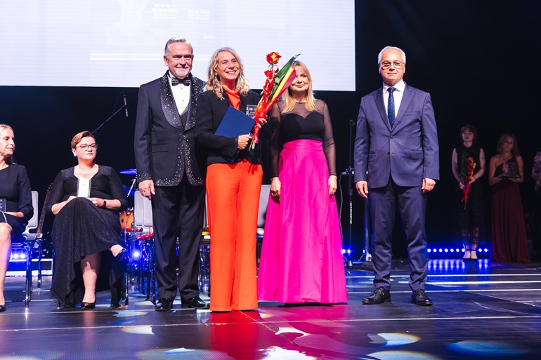 na scenie stoją cztery osoby dwóch mężczyzn i dwie kobiety