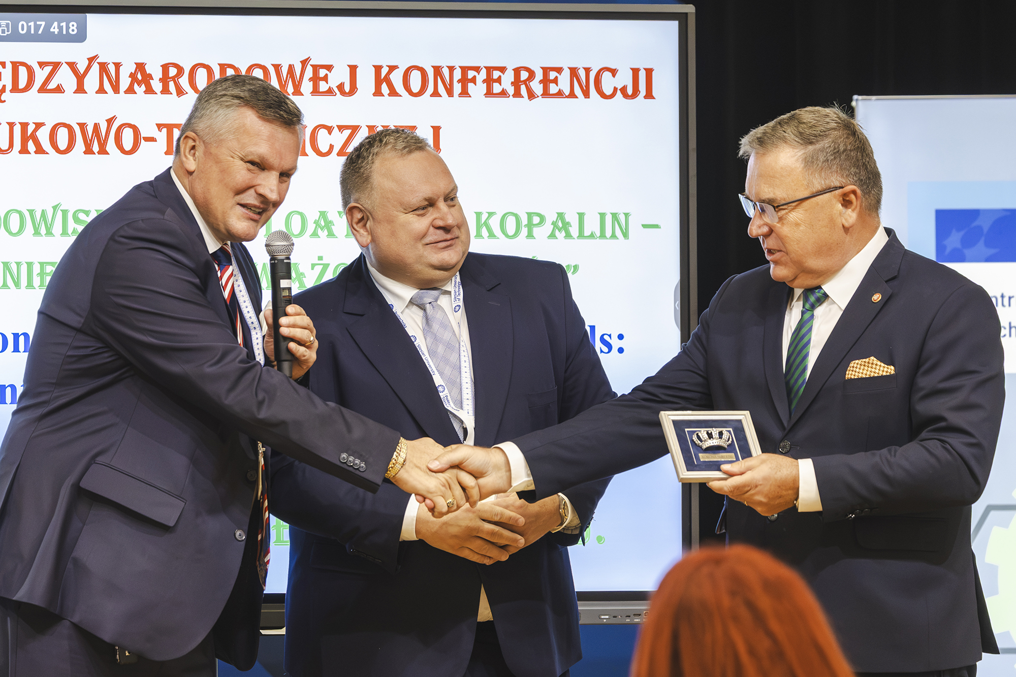 na zdjęciu widzimy trojkę mężczyzn, którzy podają sobie dłonie